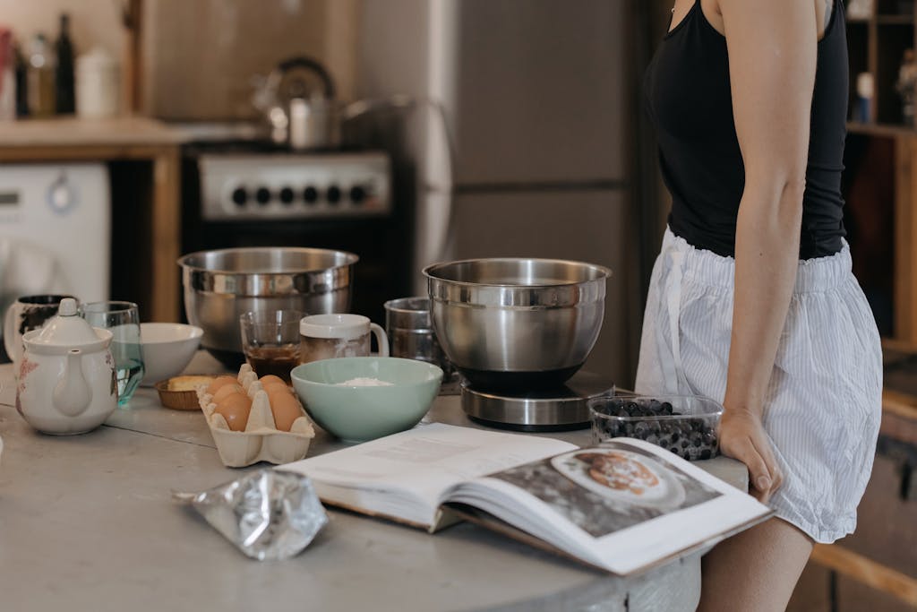 Woman in Black Shirt Standing in Front of Table With Bowls