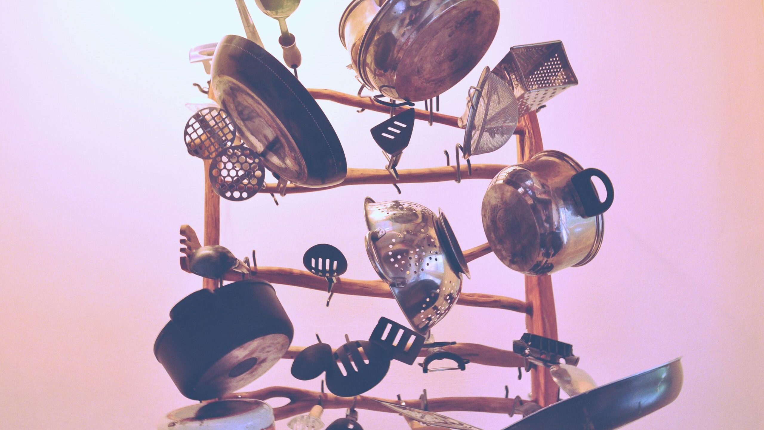 Kitchen Cookware Piled Up on Brown Wooden Rack